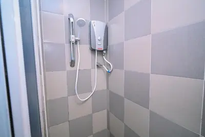 a shower in a bathroom with purple and white tiles at Kingston Hotel 1 - Bukit Bintang in Kuala Lumpur