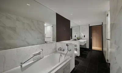 a large bathroom with a tub and a sink at PARKROYAL COLLECTION Kuala Lumpur in Kuala Lumpur