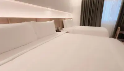 a large white bed in a hotel room at The Federal Kuala Lumpur in Kuala Lumpur
