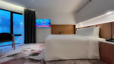 a hotel room with a large bed and a tv at The Federal Kuala Lumpur in Kuala Lumpur