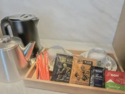 a tray filled with books and a coffee pot at The Federal Kuala Lumpur in Kuala Lumpur