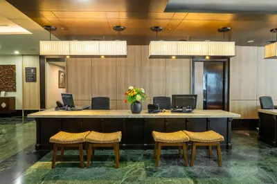 a lobby with a large desk with two computers on it at Micasa All Suites Hotel in Kuala Lumpur