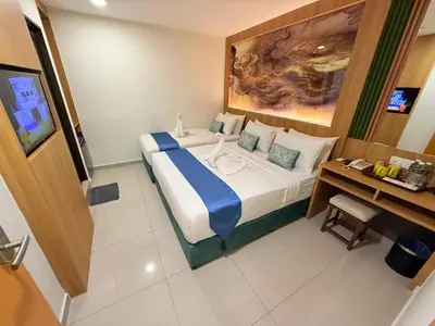 a hotel room with a bed and a desk at City Central Hotel in Kuala Lumpur
