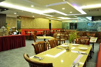 a dining room with tables and chairs and a restaurant at City Central Hotel in Kuala Lumpur