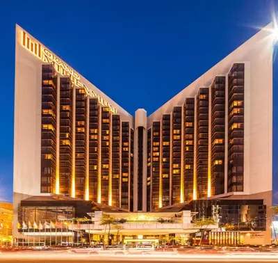 a large hotel building with lights on at Grand Millennium Kuala Lumpur in Kuala Lumpur