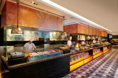 two chefs preparing food in a restaurant kitchen at Concorde Hotel Kuala Lumpur in Kuala Lumpur