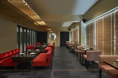a dining room with tables and red chairs at Concorde Hotel Kuala Lumpur in Kuala Lumpur