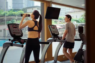 a man and a woman on a treadmill in a gym at Concorde Hotel Kuala Lumpur in Kuala Lumpur