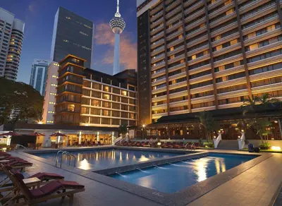 a large swimming pool in a city with buildings at Concorde Hotel Kuala Lumpur in Kuala Lumpur