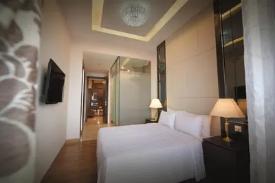 a bedroom with a white bed and a television at Dorsett Kuala Lumpur in Kuala Lumpur
