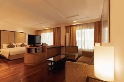 a hotel room with a bed and a television at Impiana KLCC Hotel in Kuala Lumpur
