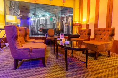 a lobby with chairs and a table in a room at Seri Pacific Hotel Kuala Lumpur in Kuala Lumpur