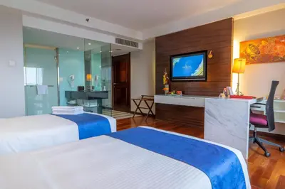 a hotel room with two beds and a television at Seri Pacific Hotel Kuala Lumpur in Kuala Lumpur