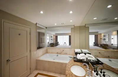 a bathroom with a tub and a sink and a bath tub at InterContinental Kuala Lumpur by IHG in Kuala Lumpur