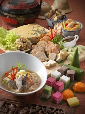 a table with a bowl of soup and a plate of food at Cititel Mid Valley in Kuala Lumpur