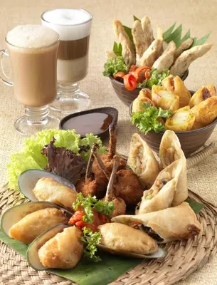 a table with a plate of food and a drink at Cititel Mid Valley in Kuala Lumpur
