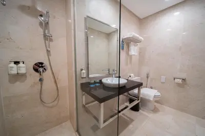 a bathroom with a shower and a sink and a toilet at St Giles Boulevard in Kuala Lumpur