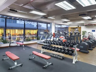 a gym with lots of treadmills and cardio machines at St Giles Boulevard in Kuala Lumpur