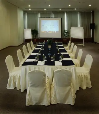 a large conference room with a long table and white chairs at Hotel Capitol Kuala Lumpur in Kuala Lumpur