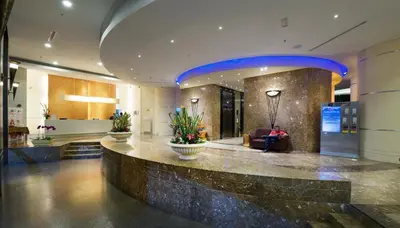 a lobby of a building with a large lobby at Hotel Royal Kuala Lumpur in Kuala Lumpur