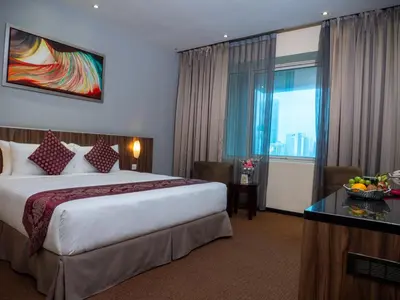 a hotel room with a large bed and a window at Hotel Royal Kuala Lumpur in Kuala Lumpur