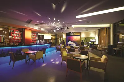 a restaurant with tables and chairs and a bar at Berjaya Times Square Hotel, Kuala Lumpur in Kuala Lumpur