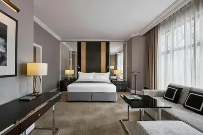 a bedroom with a bed and a living room at The Ritz-Carlton, Kuala Lumpur in Kuala Lumpur