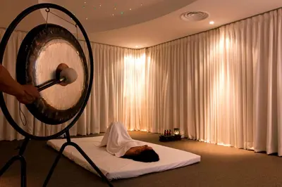 a cat laying on a bed in a room at The Ritz-Carlton, Kuala Lumpur in Kuala Lumpur