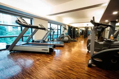 a gym with several treadmills and elliptical machines at Hotel Maya Kuala Lumpur City Centre in Kuala Lumpur