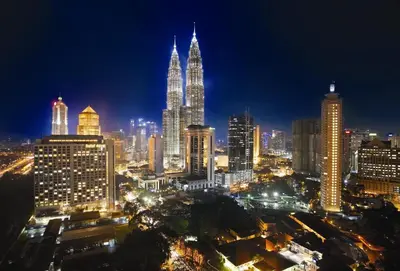 a night view of a city skyline with tall buildings at Hotel Maya Kuala Lumpur City Centre in Kuala Lumpur