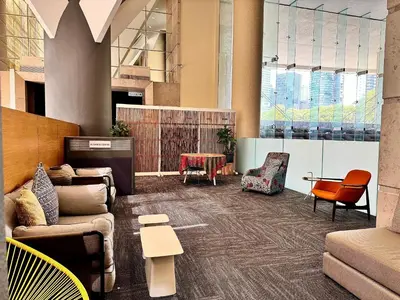 a lobby with couches and chairs and a table at Hotel Maya Kuala Lumpur City Centre in Kuala Lumpur