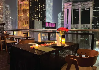 a restaurant with a view of a city at night at Hotel Maya Kuala Lumpur City Centre in Kuala Lumpur