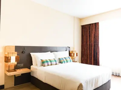 a bedroom with a large bed and a window at Starus Hotel Bukit Bintang in Kuala Lumpur