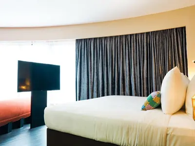a hotel room with a bed and a large window at Starus Hotel Bukit Bintang in Kuala Lumpur