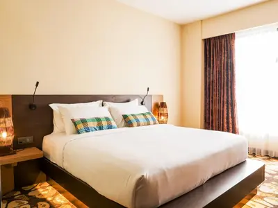 a bedroom with a large bed and a window at Starus Hotel Bukit Bintang in Kuala Lumpur