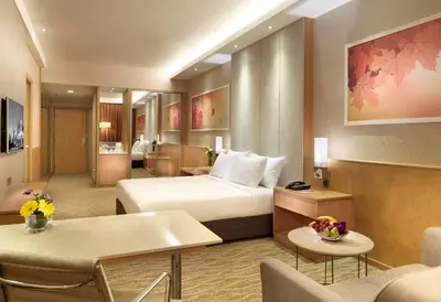 a hotel room with a bed and a living room at Sunway Putra Hotel Kuala Lumpur in Kuala Lumpur