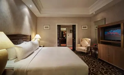 a hotel room with a bed and a flat screen tv at Sunway Putra Hotel Kuala Lumpur in Kuala Lumpur