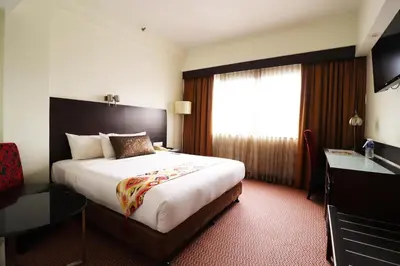 a hotel room with a large bed and a window at Hotel Grand Continental Kuala Lumpur in Kuala Lumpur