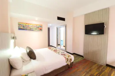 a hotel room with a bed and a flat screen tv at Hotel Grand Continental Kuala Lumpur in Kuala Lumpur