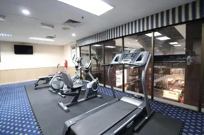 a gym with treadmills and ellipticals in a building at Hotel Grand Continental Kuala Lumpur in Kuala Lumpur