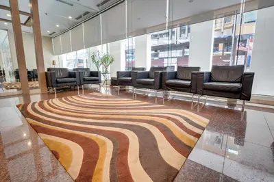 a lobby with chairs and a rug on the floor at Prescott Hotel Kuala Lumpur Medan Tuanku in Kuala Lumpur