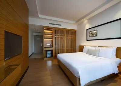 a bedroom with a large bed and a flat screen tv at ANSA Hotel Kuala Lumpur in Kuala Lumpur