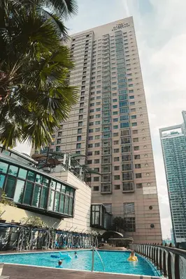 a large building with a swimming pool in front of it at St Giles Mid Valley Kuala Lumpur in Kuala Lumpur