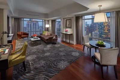 a living room with a couch and a table at Mandarin Oriental, Kuala Lumpur in Kuala Lumpur