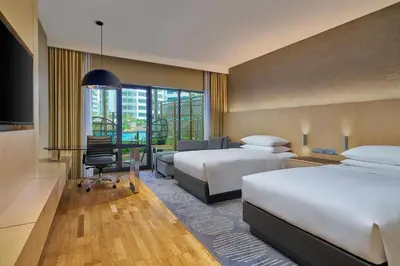 a hotel room with two beds and a desk at Renaissance Kuala Lumpur Hotel & Convention Centre in Kuala Lumpur