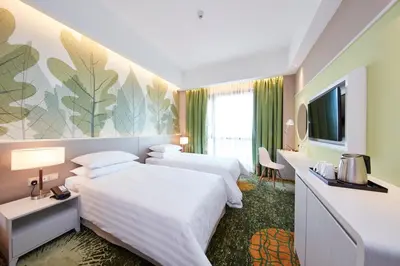 a hotel room with two beds and a flat screen tv at Sunway Velocity Hotel Kuala Lumpur in Kuala Lumpur