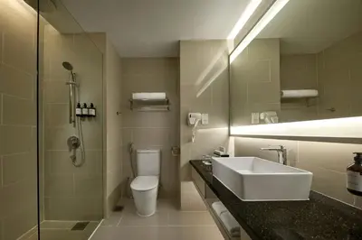 a bathroom with a sink and a toilet and a shower at AC Hotel by Marriott Kuala Lumpur in Kuala Lumpur