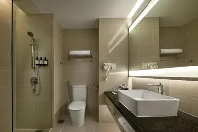a bathroom with a sink and a toilet and a shower at AC Hotel by Marriott Kuala Lumpur in Kuala Lumpur