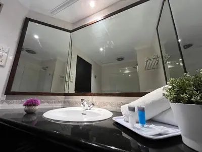 a bathroom with a sink and a large mirror at Flamingo Hotel By The Lake, Kuala Lumpur in Kuala Lumpur