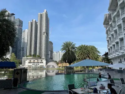 a pool in the middle of a city with tall buildings at Flamingo Hotel By The Lake, Kuala Lumpur in Kuala Lumpur